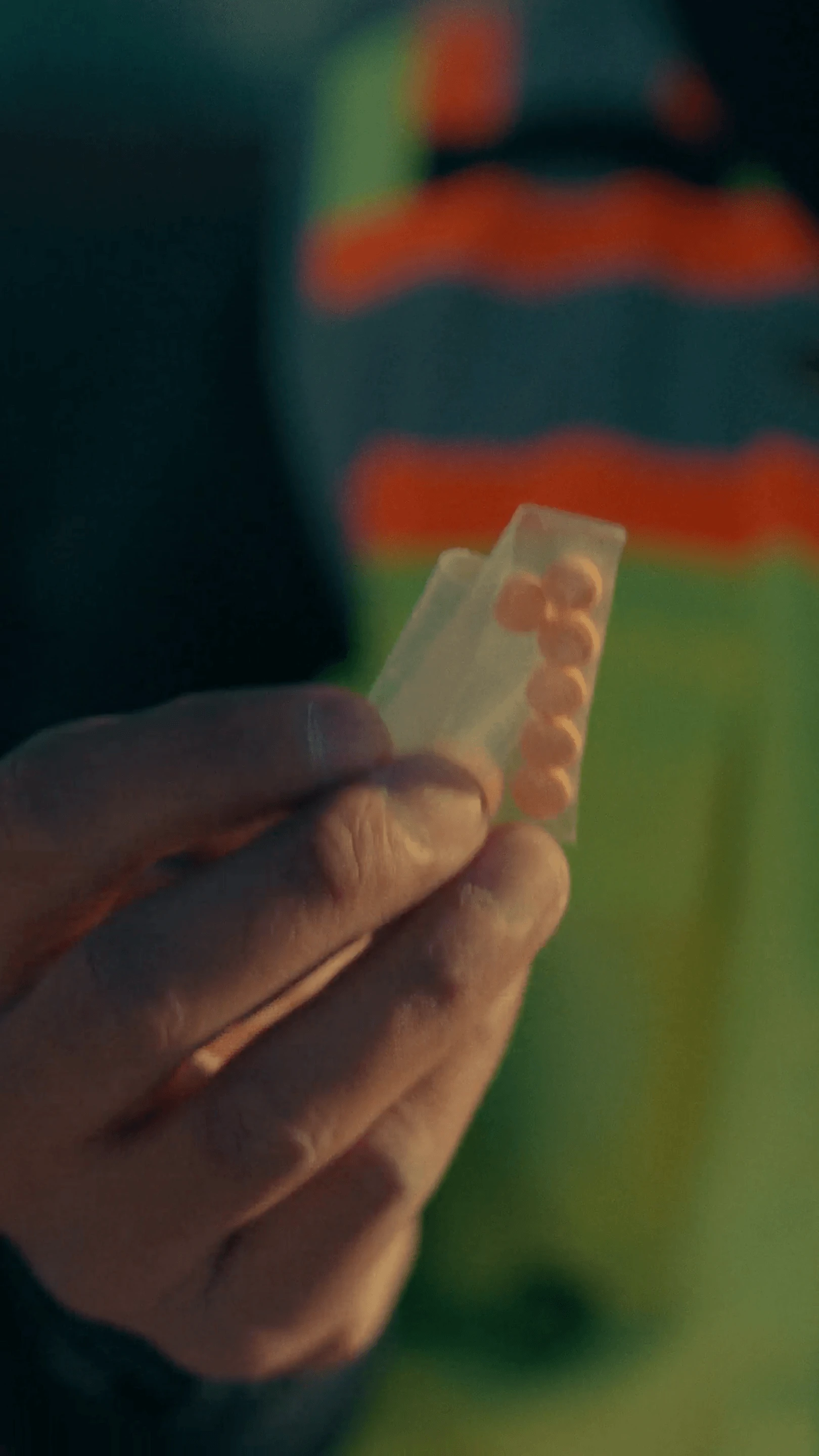 A construction worker holds a container of pills
